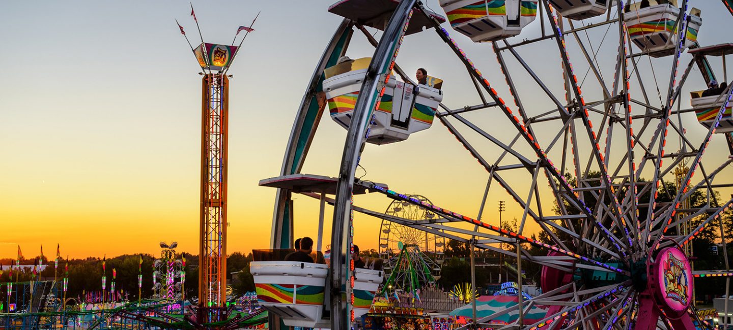 Ferris wheel and fairgrounds at sunset